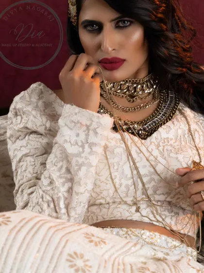 A powerful and direct portrait from a creative shoot. This look is all about glamour and confidence, with striking eye makeup and a perfectly defined red lip that commands attention.