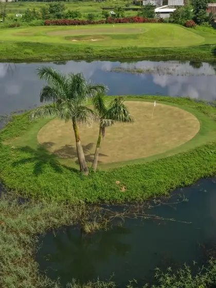 Welcome to our slice of paradise in Karjat. This aerial view showcases one of our signature water hazards, an island green that challenges your accuracy while offering stunning scenery.