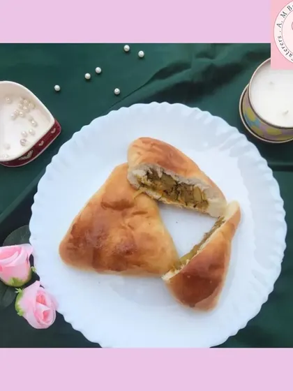 A closer look at my popular aaloo bun, cut open to show the generous spiced potato filling inside. The bun is soft and freshly baked, making it a perfect savory snack.