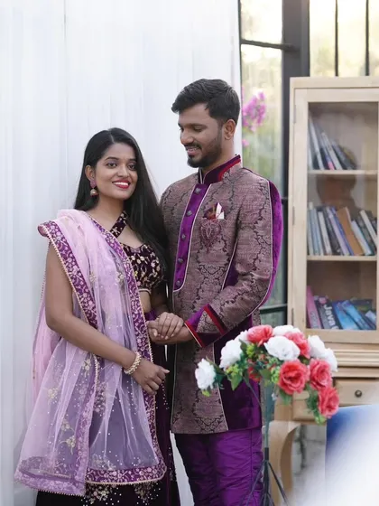 A classic couple's portrait showing off our coordinated ethnic wear. This deep purple lehenga and matching sherwani are perfect for a traditional pre-wedding photoshoot.