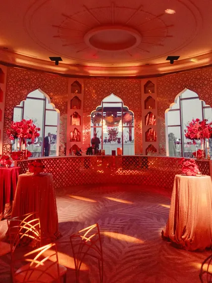 The entrance to the Sangeet was a grand, circular room with a custom bar, all bathed in a passionate red light, setting the tone for a royal affair.