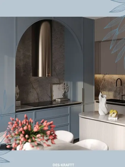 An arched niche for the cooktop, framed by dusty blue cabinetry, creates a unique focal point in this kitchen. The fluted island adds a soft, textural element.