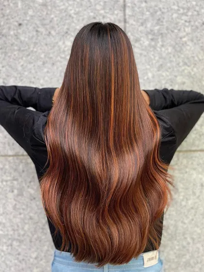 A stunning example of copper hair, which is a fantastic choice for Indian skin tones. The fiery tones add vibrancy and radiance.
