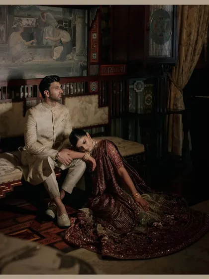 A dramatic, painterly portrait of a couple at the Taj Falaknuma Palace. The composition and lighting are inspired by classical art, creating a truly unique and luxurious wedding photograph.