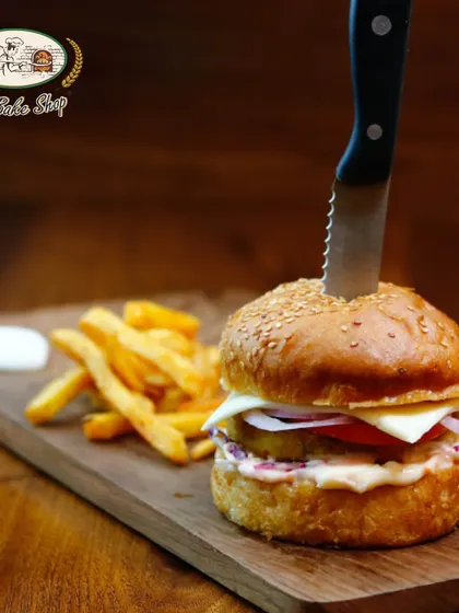 Beyond the sweets, we also craft delicious savoury options like this hearty Veg Burger. Served on our freshly baked bun with a side of fries, it's a satisfying meal for any time of day.
