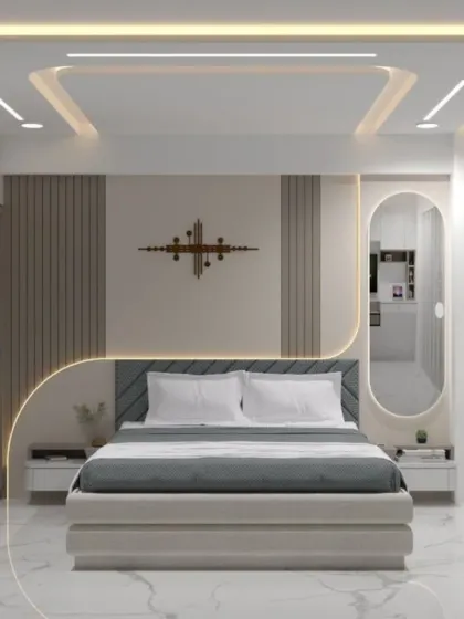 This bedroom showcases our expertise in ceiling design, with multi-level trays and recessed lighting that add depth and drama. The curved lines are echoed in the headboard and mirror, creating a harmonious and futuristic look.