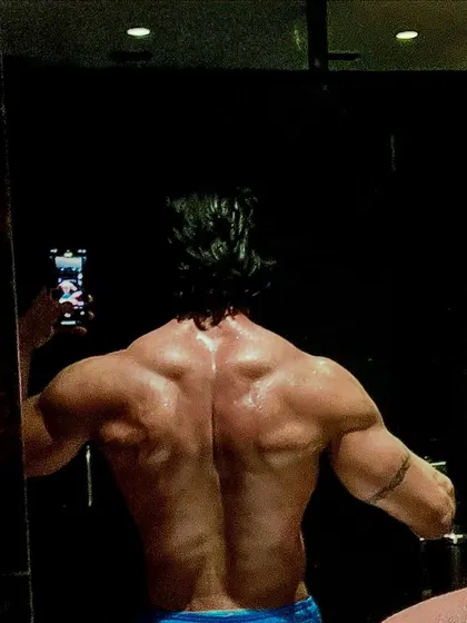 A slightly different angle of a back selfie, highlighting the muscle separation and detail that comes from a well-rounded training program.