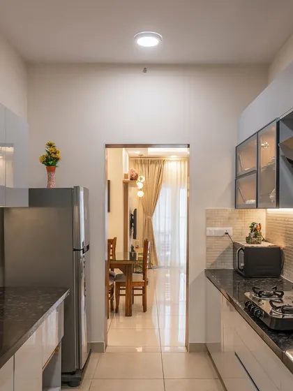 A galley kitchen designed for efficiency. The layout provides ample counter space on both sides, with a combination of closed and glass-front cabinets for varied storage options.