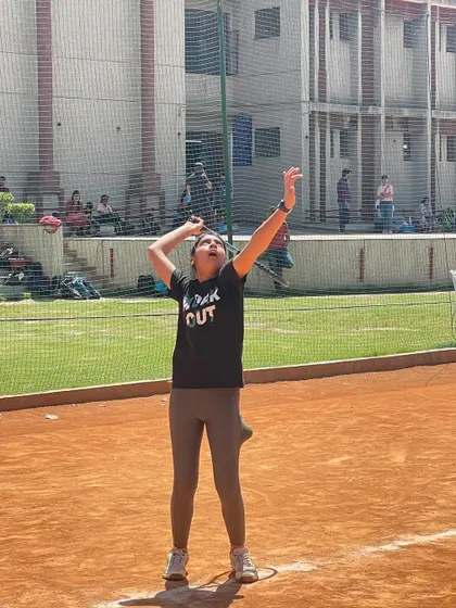 A player tossing the ball for a serve during a tournament. The service toss is a critical component that we practice relentlessly.