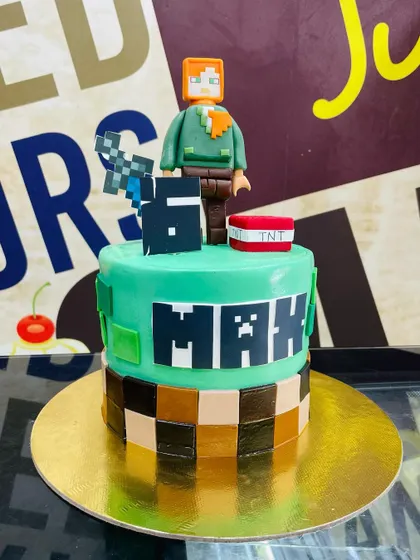 A 2.5kg Minecraft cake perfect for a gamer's birthday, featuring a fondant character, TNT block, and pixelated design.