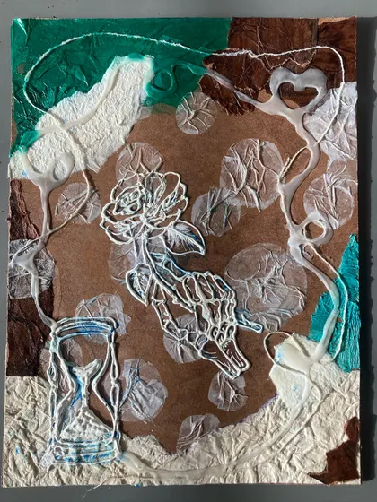 An example of a collagraph plate created by one of our students. This piece uses string and textured paper to form a delicate design of a rose and an hourglass, ready to be inked for printing.