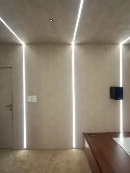 This compact home cinema features a unique design where a raised platform with a mattress serves as the primary seating, creating a very casual and cozy space.