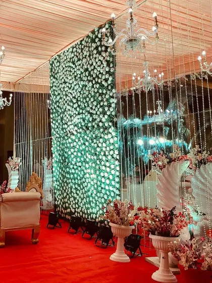 Another view of the elegant indoor stage, this time with a focus on the beautiful white floral arrangements.