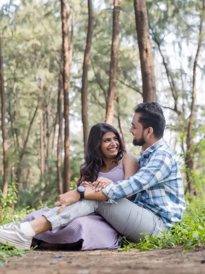 A candid, happy moment shared between the couple while sitting amidst the trees. These relaxed, unposed shots are perfect for telling your authentic love story.