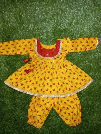 A smaller version of the same yellow and red floral print outfit, designed for a 1-month-old baby.