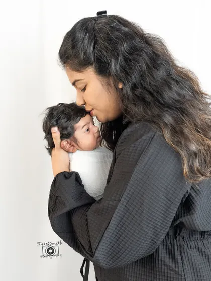 A mother's gentle kiss on her baby's forehead. These simple acts of love are the most beautiful to photograph, creating timeless and emotional portraits.
