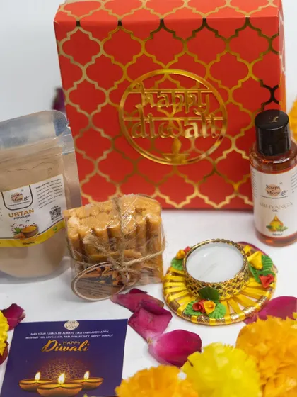 This festive red Diwali hamper includes Ubtan powder, Abhyanga oil, a stack of our handmade soaps, and a decorative diya. It's a complete package for a traditional and rejuvenating celebration.