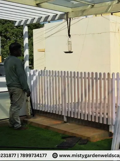The completed wooden picket fence, providing a clean boundary and a touch of classic style to the terrace garden.