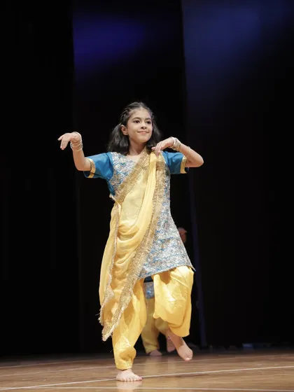 A beautiful shot of a 'Dancing Divaa' performing a traditional dance step.