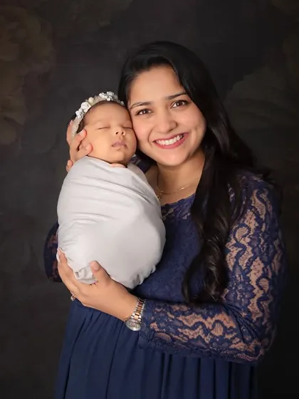 A mother's embrace is the safest place on earth. This classic portrait of a mom holding her sleeping newborn is a must-have shot that you will treasure forever.