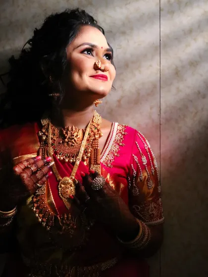 A beautiful shot of the bride looking up, the light catching her glowing skin and the intricate details of her jewelry.