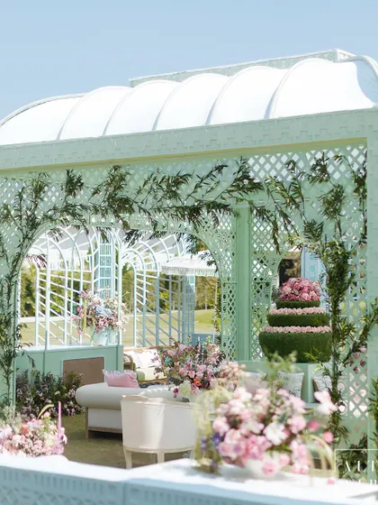 A whimsical trellis structure from the 'Mayfair Luncheon', filled with lush florals and elegant seating. The design was meant to be not too much, not too little, just pure, easy elegance.