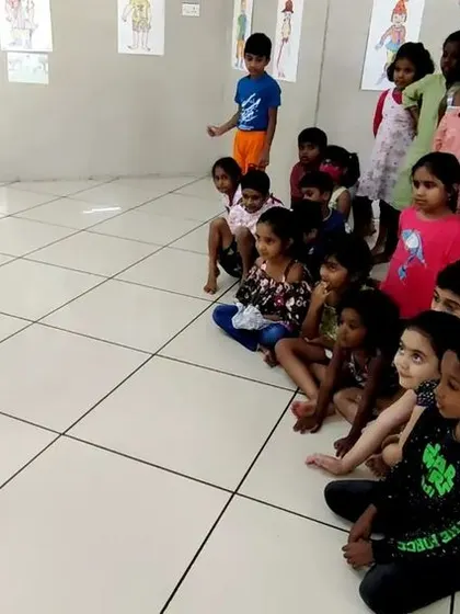 Children watching intently as a marionette puppet is demonstrated in one of our puppetry classes.