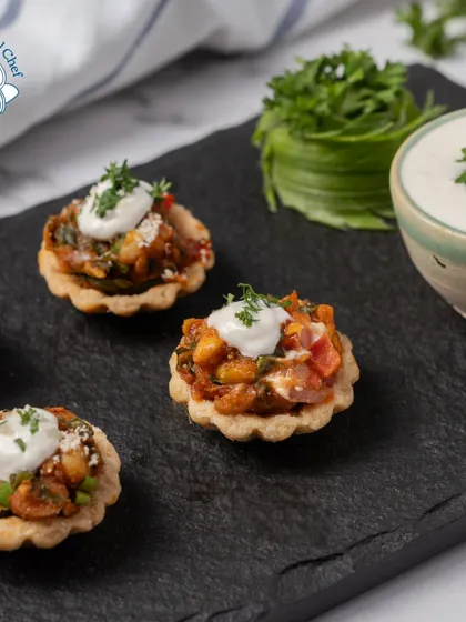 Another look at my mini Mexican tarts, topped with a dollop of sour cream and fresh parsley. These bite-sized treats are perfect for passing around at a cocktail party.
