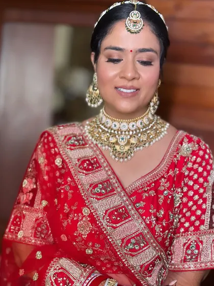 A close-up of Khushi's makeup. The soft shimmer on the lids and the perfectly blended base are key to this timeless bridal style.