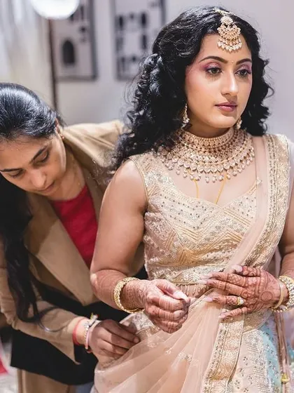 Candid shots of me in action, getting the bride ready for her big day. I take care of both makeup and final draping to ensure every detail is perfect.