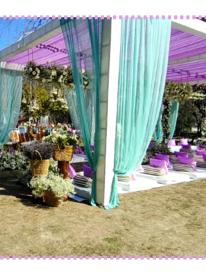 A wide view of an outdoor wedding setup in Jim Corbett, with elegant drapes and decor that enhance the natural beauty of the location.