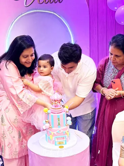 The happy family cutting the rotating carousel cake. It's moments like these that I cherish.