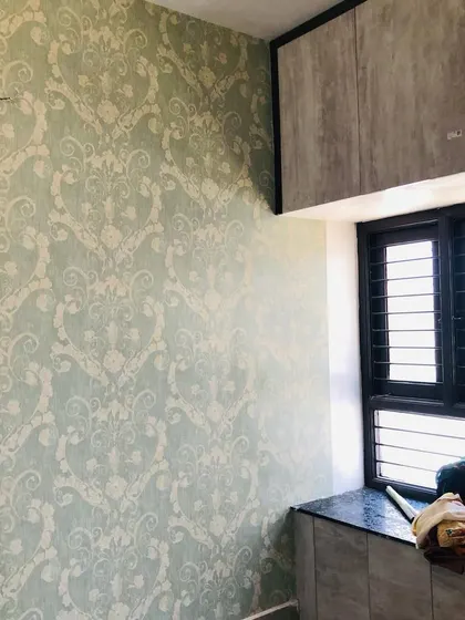 The sage green damask wallpaper shown in a different corner, demonstrating how I work around windows and built-in furniture.