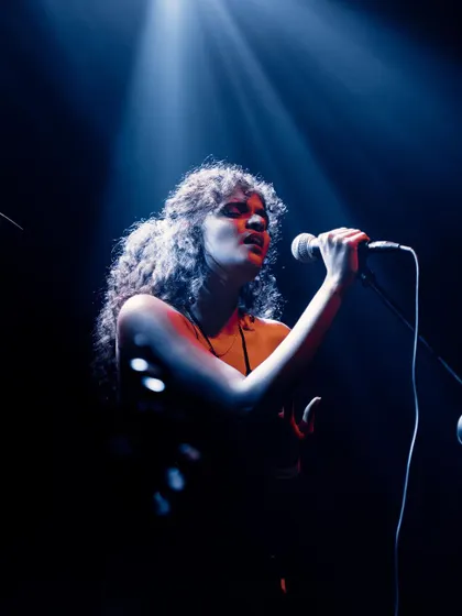 A duplicate of 67, this photo captures me completely absorbed in the song, a moment of pure musical expression on stage.