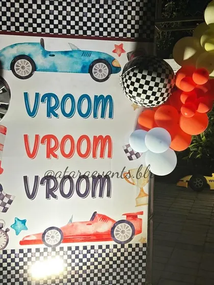 A detailed shot of the "Vroom Vroom" entrance panel, showcasing the checkered pattern and colorful balloon accents that welcome guests to the party.