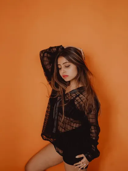 This image has a thoughtful, introspective mood, enhanced by the simple styling and the bold color of the background.