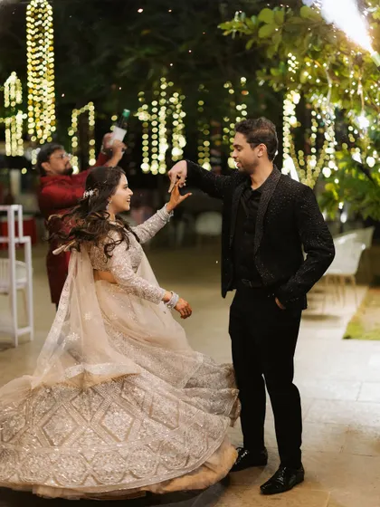 A couple shares a dance, lost in each other's eyes under the warm glow of twinkling lights. My goal is to create an atmosphere where these magical moments can unfold naturally.