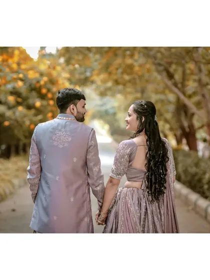 A simple, heartfelt shot from behind as the couple holds hands. This perspective in couple photography emphasizes their connection and shared journey forward.