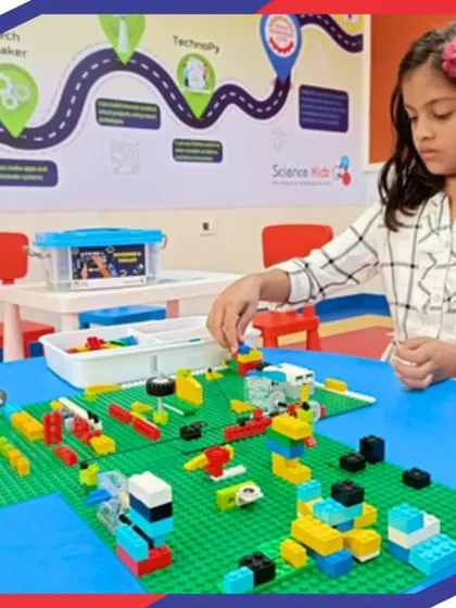 A student carefully assembles a project on a LEGO baseplate. This kind of focused, hands-on activity is central to our teaching method, helping develop fine motor skills, spatial reasoning, and patience.