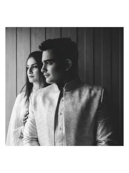 A classic black and white portrait using shadows and light to create a dramatic, high-contrast image. This technique adds a sense of sophistication and artistry to engagement photography.