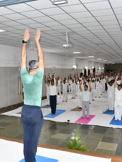 An instructor from our Goa branch leads soldiers in standing asanas during the International Day of Yoga session at the military camp.