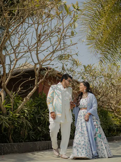 A candid walking shot of the couple in a beautiful outdoor setting. Natural light and surroundings create a relaxed and authentic feel.