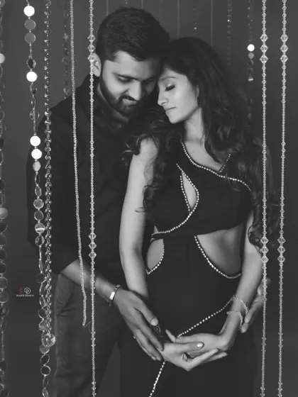 This black and white version of a glamorous couple's shoot adds a layer of classic Hollywood elegance. The lighting and emotion are the true stars of the photo.