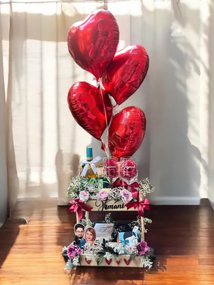 Celebrate your love story with a grand gesture. This anniversary hamper combines romantic elements like heart-shaped balloons, fine wine, personalized photo frames, and fresh flowers to create a breathtaking moment.