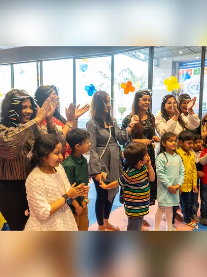 Guests clap and cheer during the cake-cutting ceremony, sharing in the birthday boy's excitement.