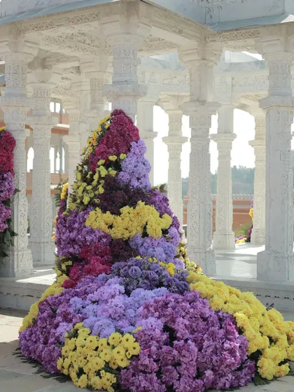 A close-up of the massive floral installation, showing the rich texture and color variation of the chrysanthemums used.