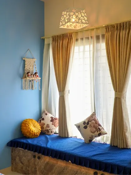 A cozy bay window seating area in a client's bedroom, showcasing how I create functional and charming nooks for relaxation.