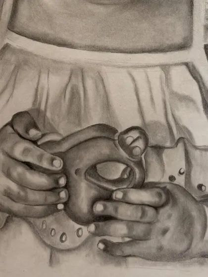 A close-up of a baby sketch, focusing on the tiny hands holding a toy. For me, these small details are what bring a portrait to life and tell a bigger story.