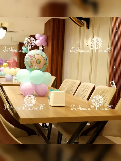 Donut-themed balloon centerpieces add a touch of sweetness to the guest tables.
