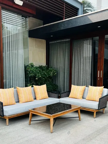 A comfortable L-shaped sofa on the pool deck provides ample seating for family and guests.